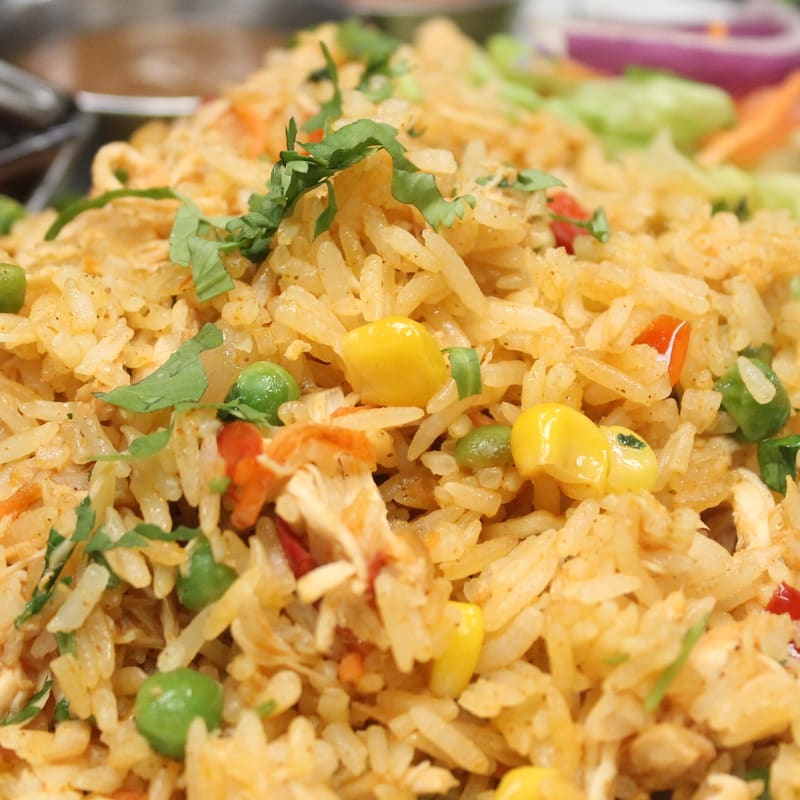 Arroz con pollo with yellow rice, black beans and chimichurri