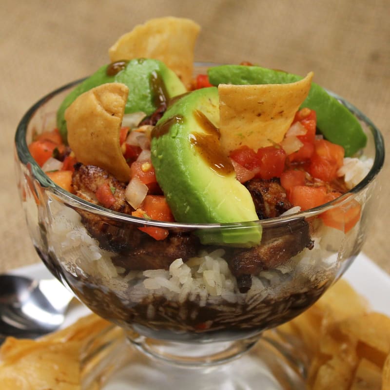 Chifrijo — black beans, rice, meat, pico de gallo and Lizano sauce