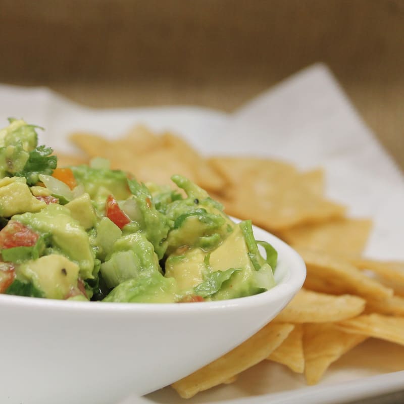 Fresh made-to-order guacamole with homemade tortilla chips